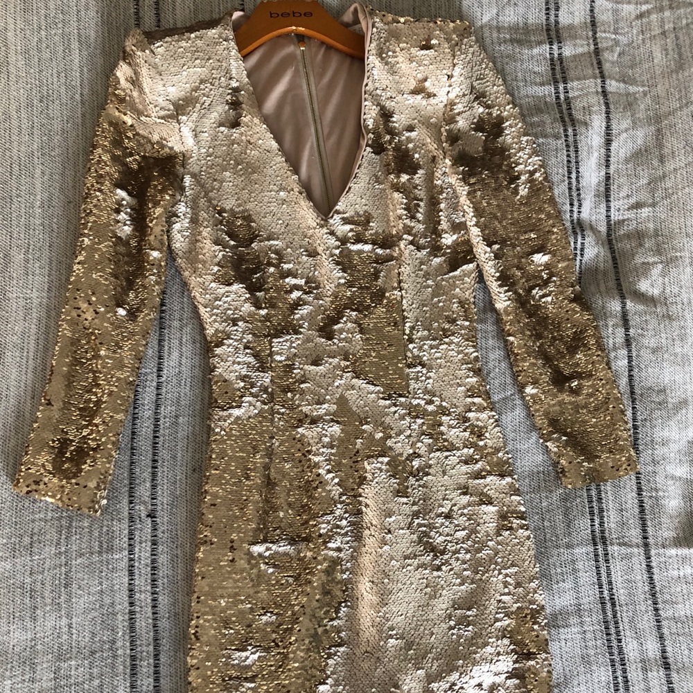 Sequined dress with deep v, and shoulder pads.